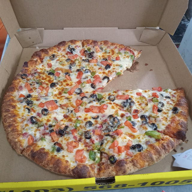 16 Pizza with Tandoori Chicken Donair Meat Green Peppers Jalapenos Banana Peppers and Garlic