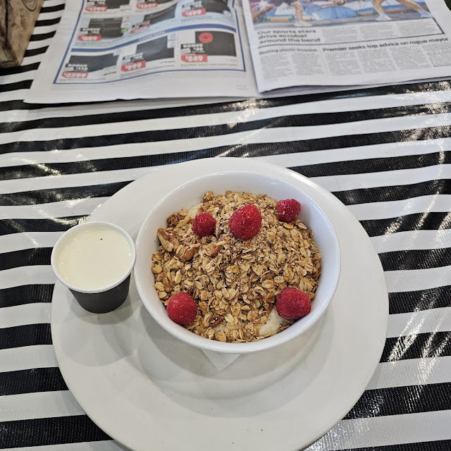 Porridge with Fresh Raspberries Granola with Syrup and Some Pouring Cream