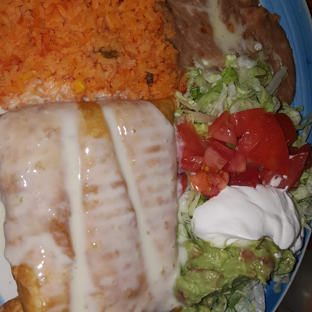 One Guacamole Tostada One Beef Enchilada Rice & Beans