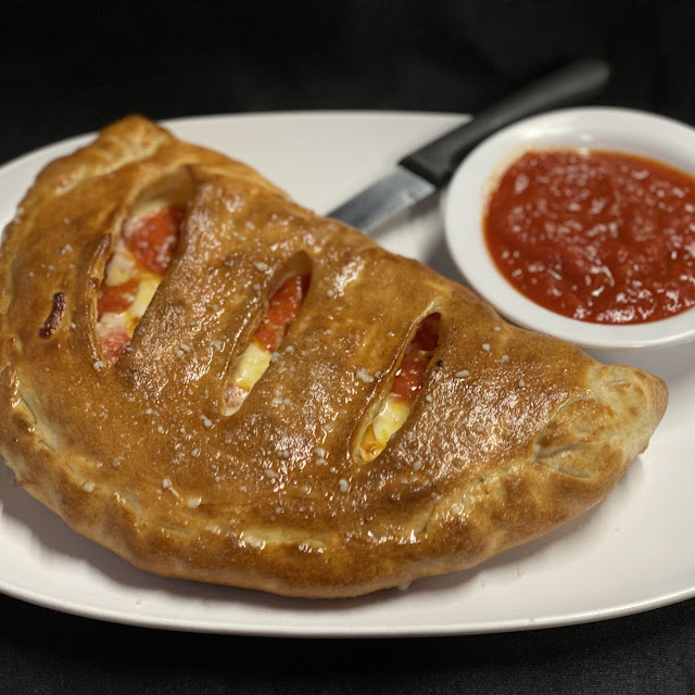 Calzone Stuffed with Ricotta Cheese or Stromboli Lined with Pizza Sauce