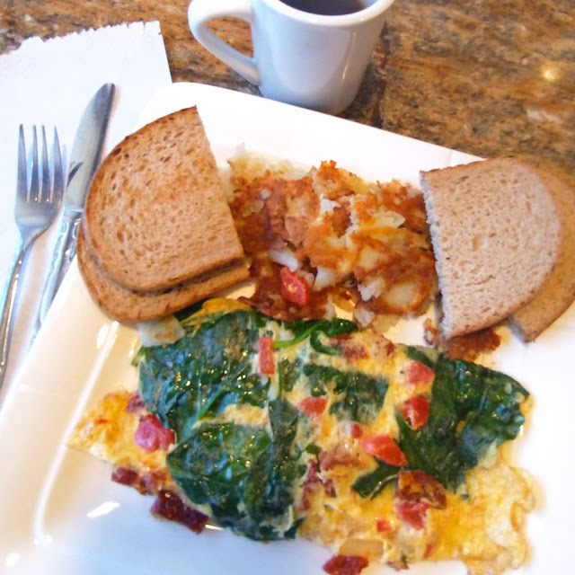 Omelette with Spinach and Sun-Dried Tomatoes Served with Breakfast Potatoes and Toast