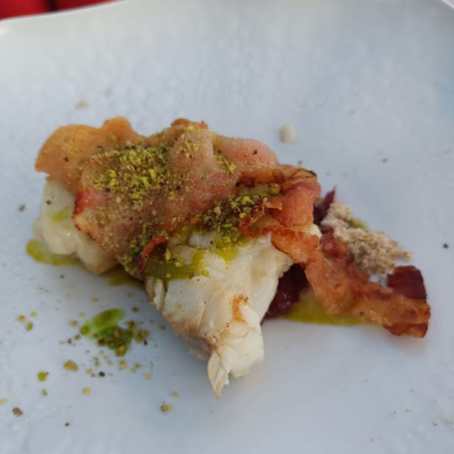Pescatora Fish Filet with Caramelized Onions and Pistachio Powder and Bacon